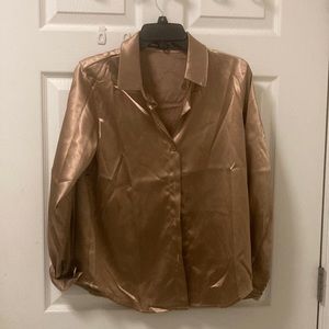 Satin, long sleeve button up shirt. Color is bronze. Looks like a gold.